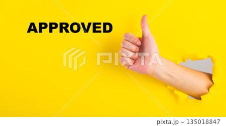 Hand giving thumbs up with approved text Hand giving thumbs up with approved text 135018847
