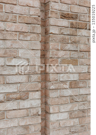 Textured brick wall corner with natural tones 135019225