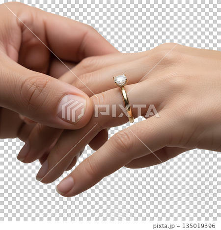 Romantic moment as a man's hand places a diamond engagement ring on a woman's finger, symbolizing marriage proposals and commitment 135019396