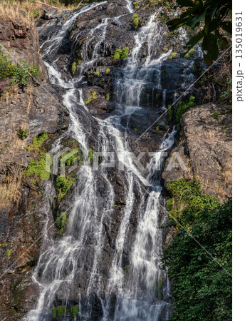 Waterfall stream falling down rocks and stones of mountain steep slope. Tropical forest in Sarika waterfall is the landmark national park of at Nakhon Nayok province, 135019631