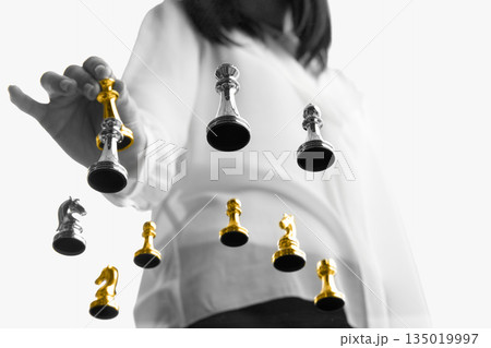 Businesswoman choosing golden chess piece among silver figures. 135019997