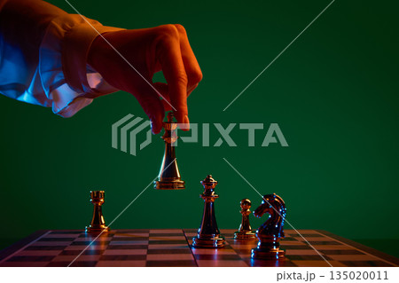 Decisive chess action as black queen is placed on board. Decisive chess action as black queen is placed on board. 135020011