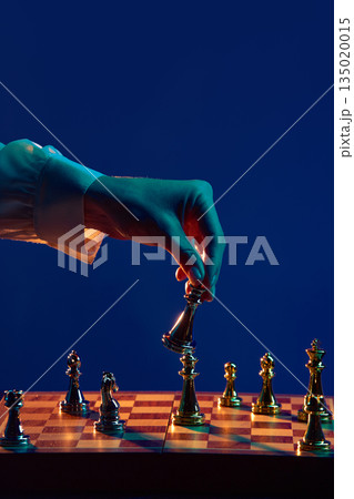 Male hand reaching to make decisive chess move. 135020015