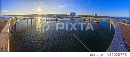 Curved pier at Timmendorfer Strand on the Baltic Sea 135020778
