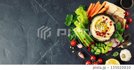 Fresh Hummus Platter with Vegetables and Pita on Dark Background Fresh Hummus Platter with Vegetables and Pita on Dark Background 135020810