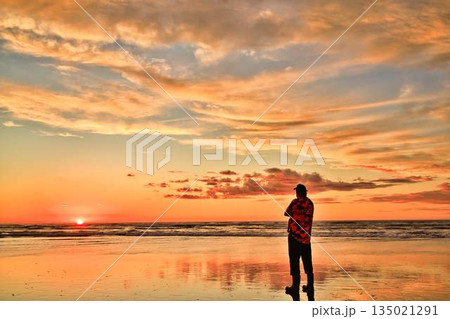 Foxton Beach New Zealand Sunset High Tide A Man Watching The Sun Go Down Foxton Beach New Zealand Sunset High Tide A Man Watching The Sun Go Down 135021291