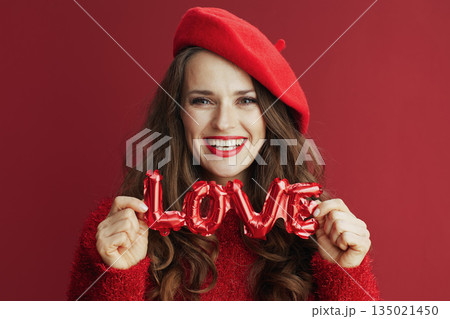 happy modern woman in red sweater and beret 135021450