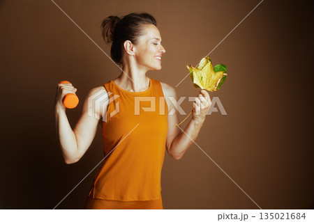 Playful Autumn Workout: Dumbbell and Leaf 135021684