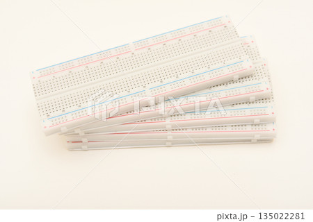 A solderless board for electronics. A breadboard for experiments in electronics. A solderless board for electronics. A breadboard for experiments in electronics. 135022281