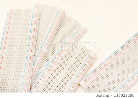 A solderless board for electronics. A breadboard for experiments in electronics. A solderless board for electronics. A breadboard for experiments in electronics. 135022286