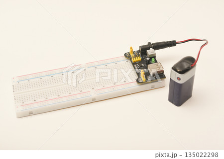 A solderless board for electronics with a battery. A breadboard for experiments in electronics. A solderless board for electronics with a battery. A breadboard for experiments in electronics. 135022298