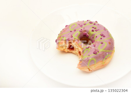 One sweet donut on a plate. A delicious sweet snack. An American doughnut. One sweet donut on a plate. A delicious sweet snack. An American doughnut. 135022304