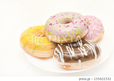 Sweet donuts on a plate. A delicious sweet snack. An American doughnut. 135022332