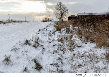 Empty snowy road in cold winter landscape 135022334