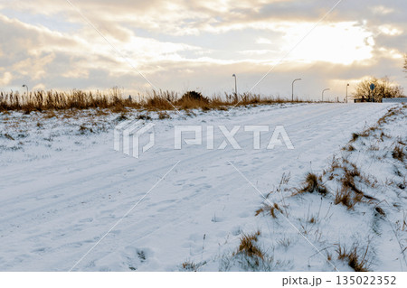 Snow covered rural road under winter sky 135022352