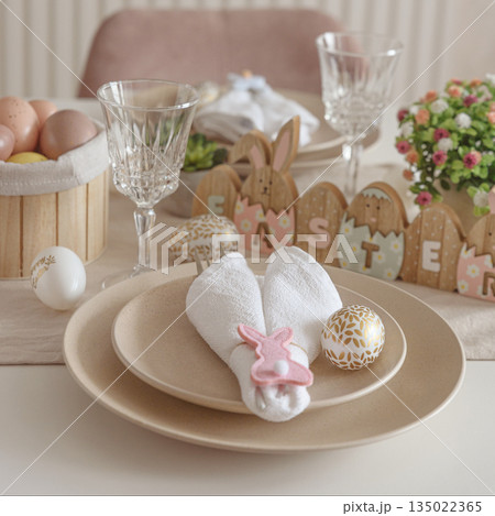 Festive Easter table setting with Easter bunny made from napkin. Easter celebration concept 135022365