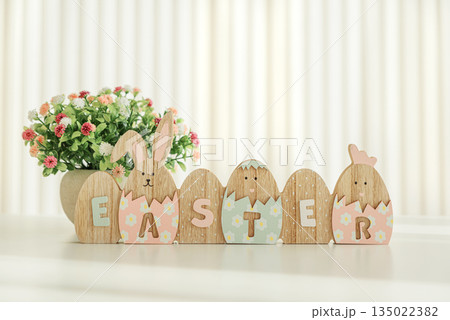 Easter decoration with easter eggs on white table under sun beams. Front view Easter decoration with easter eggs on white table under sun beams. Front view 135022382