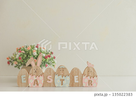 Easter decoration with easter eggs on white table under sun beams. Front view Easter decoration with easter eggs on white table under sun beams. Front view 135022383