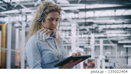 Focused Female Technical Specialist Conducting Digital Diagnostics in Industry 4.0 Facility 135022404