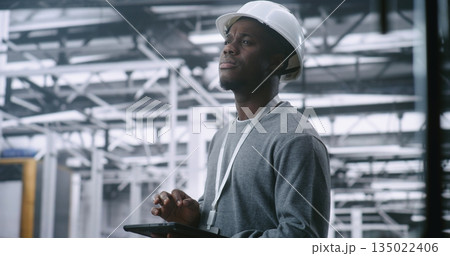 Dedicated Technician Concerned Expression While Holding Tablet, Suggesting Troubleshooting Dedicated Technician Concerned Expression While Holding Tablet, Suggesting Troubleshooting 135022406