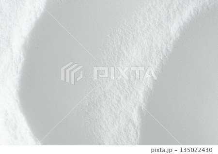 Soda powder sodium bicarbonate surface. Abstract white background. White texture with wavy patterns top view Soda powder sodium bicarbonate surface. Abstract white background. White texture with wavy patterns top view 135022430