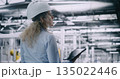 Female Technical Supervisor in Safety Gear, Overseeing Complex Machinery on Smart Factory 135022446