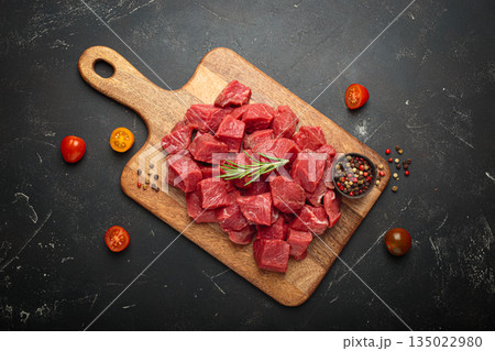 Diced cut raw beef cubes wooden cutting board red meat cooking protein top view Diced cut raw beef cubes wooden cutting board red meat cooking protein top view 135022980