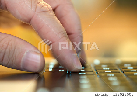 Hand typing on a keyboard while working Hand typing on a keyboard while working 135023006