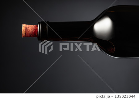 An almost opened bottle of red wine. An almost opened bottle of red wine. 135023044