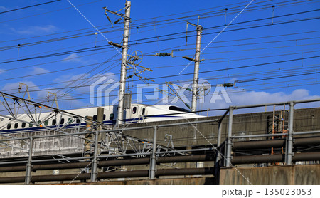 Shinkansen bullet train travels over a bridge in Kitakyushu, Fukuoka Japan. Shinkansen bullet train travels over a bridge in Kitakyushu, Fukuoka Japan. 135023053