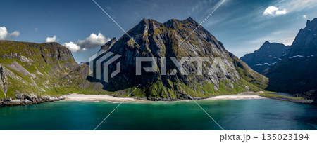 Kvalvika Sand Beach With Mountains And Ocean On Lofoten Islands In Norway Kvalvika Sand Beach With Mountains And Ocean On Lofoten Islands In Norway 135023194