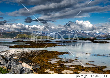 Coastal Landscape With Calm Fjord And Snowy Mountains At Sommaroy In Norway 135023311