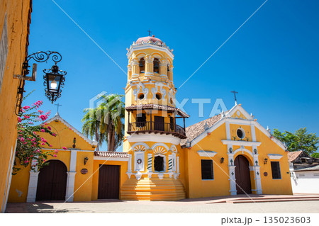 The beautiful historic Church of Santa Barbara built in 1613 with a balcony on its bell tower at the colonial Heritage Town of Santa Cruz de Mompox in Colombia. 135023603