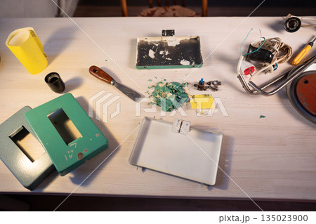 Worktable with tools and instruments at workshop, disassembling and restoring process of old lamp. Worktable with tools and instruments at workshop, disassembling and restoring process of old lamp. 135023900