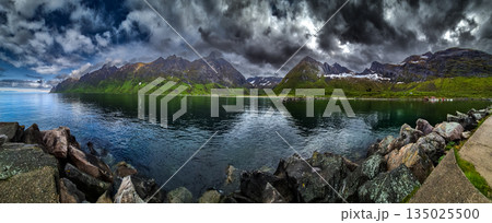 Calm Fjord With Red Huts In Front Of Snowy Mountains On Senja Island In Norway Calm Fjord With Red Huts In Front Of Snowy Mountains On Senja Island In Norway 135025500