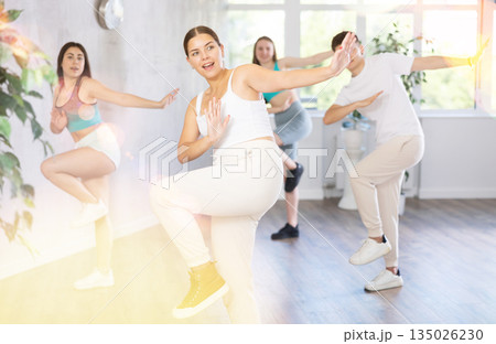 Teenagers practicing breakdance toprock moves in training hall. Teenagers engaged in breakdance Teenagers practicing breakdance toprock moves in training hall. Teenagers engaged in breakdance 135026230