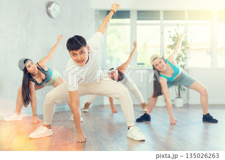 Group of young women and young guy dancing hip hop Group of young women and young guy dancing hip hop 135026263