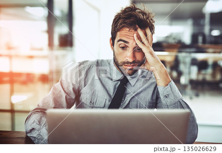 Businessman, laptop and headache in stress, burnout or overworked from strain at the office desk. Frustrated man person or employee with bad head pain or confused working on computer at the workplace Businessman, laptop and headache in stress, burnout or overworked from strain at the office desk. Frustrated man person or employee with bad head pain or confused working on computer at the workplace 135026629