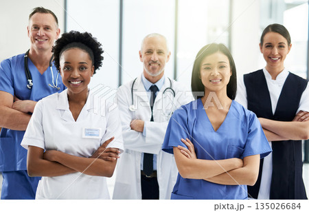Confidence, crossed arms and portrait of team of doctors standing in the hallway with collaboration. Happy, diversity and group of healthcare workers in the corridor of a medical clinic or hospital. 135026684