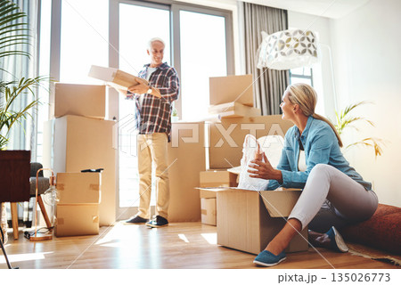 Real estate, property and a senior couple moving house while packing boxes together in their home. Box, investment and retirement with old people unpacking in the living room of their new apartment Real estate, property and a senior couple moving house while packing boxes together in their home. Box, investment and retirement with old people unpacking in the living room of their new apartment 135026773