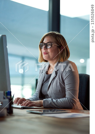 Computer, typing and business woman in office working late on project at night alone. Desktop, professional and female accountant writing email, report or planning, reading and overtime for deadline. Computer, typing and business woman in office working late on project at night alone. Desktop, professional and female accountant writing email, report or planning, reading and overtime for deadline. 135026849