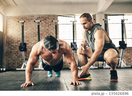 Man, coach and motivation for pushup on gym floor for fitness, health and building muscle for sport. Personal trainer, bodybuilder men and workout with advice, helping hand and together for support 135026896