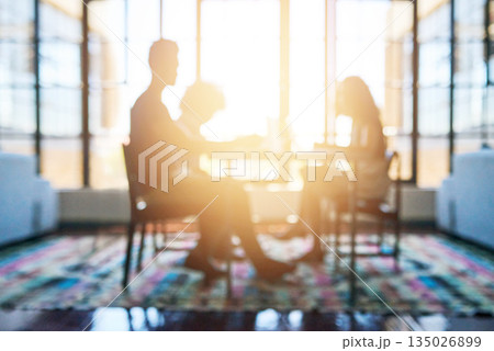 Silhouette, people in business meeting and lens flare or sunlight in modern office planning. Teamwork or collaboration, support and colleagues talking or discussing together at desk in workplace Silhouette, people in business meeting and lens flare or sunlight in modern office planning. Teamwork or collaboration, support and colleagues talking or discussing together at desk in workplace 135026899