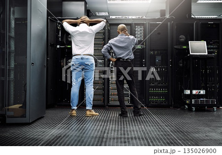 Server room, it support or electrician fixing a problem for hardware maintenance or stressful glitch crisis. Confused or back of worried technicians or electrical engineers in information technology 135026900