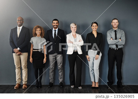 Diversity, smile and portrait of business people in studio for support, community and teamwork. Happy, collaboration and professional with employees and wall background for motivation and mission Diversity, smile and portrait of business people in studio for support, community and teamwork. Happy, collaboration and professional with employees and wall background for motivation and mission 135026905