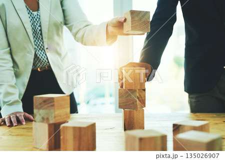 Teamwork, building blocks and business people in office, design challenge and problem solving at startup. Engineering, architecture and strategy with wood block game, man and woman working together. 135026907