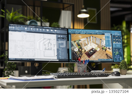 Modern architecture workspace featuring dual monitors with 3D rendering software and floor plan layouts on screen. Interior design, drafting and engineering focused on creativity and innovation. 135027104