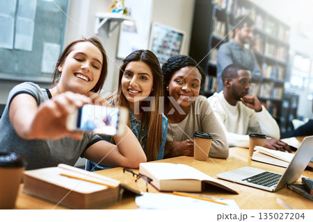 Women friends, selfie and college library with smile, happiness or diversity for social media app. Girl, group and happy for photography, profile picture or blog for solidarity, education or support Women friends, selfie and college library with smile, happiness or diversity for social media app. Girl, group and happy for photography, profile picture or blog for solidarity, education or support 135027204