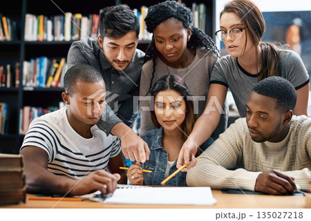 People, students in library and studying for exam or research for project, education and teamwork. Diversity, young men and women in study group and learning with collaboration on university campus 135027218