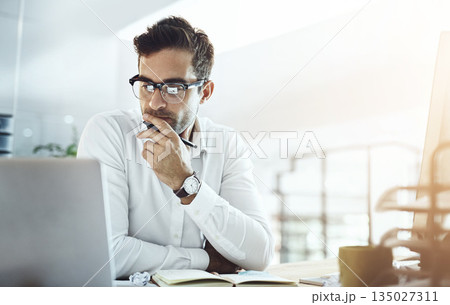 Computer, thinking and business man in office, working on project or email. Laptop, professional and male person problem solving, looking for solution or planning, reading or focus on decision making 135027311